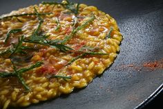 a close up of a plate of food with sauce and garnishes on it