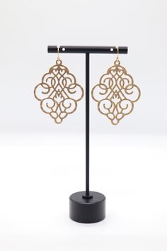 Gold Filigree Dangling Earrings are intricately designed, featuring delicate gold filigree work that creates an elegant, lace-like pattern. They hang gracefully, offering a touch of sophistication and timeless beauty, perfect for adding a refined statement to any outfit. Elegant Gold-tone Filigree Jewelry, Elegant Gold-tone Jewelry With Filigree, Elegant Antique Gold Pierced Earrings, Gold Ornate Chandelier Earrings With Intricate Design, Elegant Bridal Earrings With Intricate Metal Design, Wedding Bronze Filigree Earrings, Elegant Antique Gold Earrings With Ear Wire, Elegant Yellow Gold Filigree Plug Earrings, Elegant Bronze Plug Earrings