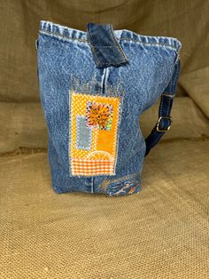 an old pair of jeans has been decorated with a colorful flower on the back pocket