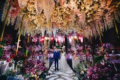 the bride and groom are standing in front of an elaborate floral arrangement at their wedding