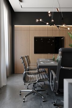 an empty conference room with chairs and a flat screen tv mounted on the wall above it