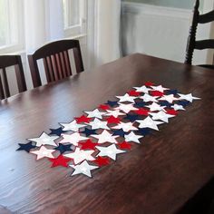 a wooden table with red, white and blue stars arranged on top of each other