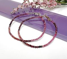 This dainty natural ruby beaded gemstone bracelet is made with small approximately 2mm to 2.5mm faceted ombre shaded Ruby gemstone beads, carefully strung on flexible aluminum wire and finished with a clasp of your choice. These gorgeous stones are not heat treated or color enhanced and show off the prettiest shades of raw ruby! 𝗢𝗣𝗧𝗜𝗢𝗡𝗦 + 𝗖𝗨𝗦𝗧𝗢𝗠𝗜𝗭𝗔𝗧𝗜𝗢𝗡 ● Different lengths are available for most pieces, allowing you to wear them as a bracelet, wrap bracelet, anklet, choker, or Ruby Beaded Bracelets With Gemstone Beads As Gift, Ruby Beaded Bracelets As A Gift, Ruby Beaded Bracelets With Round Beads As Gift, Ruby Beaded Bracelets With Round Beads For Gift, Gift Ruby Gemstone Beaded Bracelets, Raw Ruby, Customised Bracelets, Bead Choker, Ruby Beads