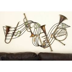 a metal wall sculpture with musical instruments on it