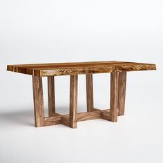 a wooden table sitting on top of a white floor