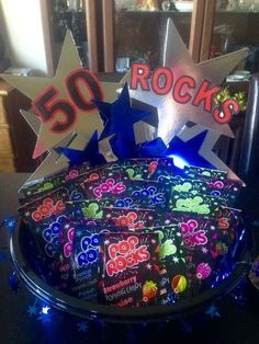 a birthday cake decorated with 50 rocks and stars