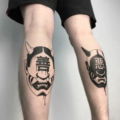 two people with tattoos on their legs, one is wearing a mask and the other has a skull