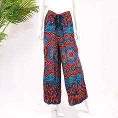 a white mannequin wearing colorful patterned pants