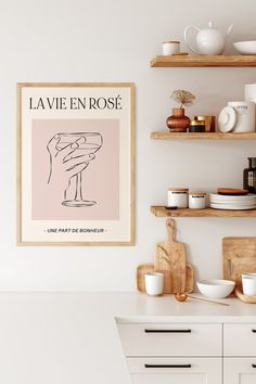 a kitchen with white cabinets and shelves filled with dishes on top of wooden shelving