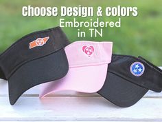 three hats with the words choose design & colors embroidered in tn on them, sitting next to each other