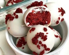 red velvet cake truffles with white frosting and sprinkles in a bowl