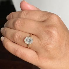 a woman's hand with a diamond ring on it