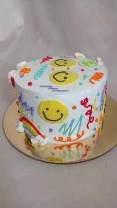 a birthday cake with smiley faces on it