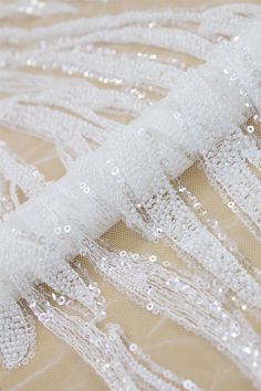 Welcome to Sunny shop. Elegant Couture Lace Fabric For Wedding Dress.Heavy Off-White Beads And Transparent Sequin Lace Fabric, Designer Lace Fabric By The Yard This lace has an amazing look and is really very heavy. It is perfect the the most unique bridal dresses. Width about: 51 inch ( 130 cm) Length : 91 Centimeters/ 1 Yard Yarn: Transparent poly yarn Mesh: Nylon Sequins: YES - Transparent Beads: YES - off-white Color: off-white 8045# Price is set for one yard. You will receive the fabric in White Organza Tulle Fabric With Sequins, White Sequined Organza Tulle Fabric, White Sequined Tulle Wedding Dress, White Beaded Tulle Fabric For Wedding, White Beaded Sequin Fabric For Wedding, White Beaded Sequin Fabric For Party, White Beaded Fitted Sequin Fabric, White Sequin Fabric For Wedding, White Tulle Fabric With Pearl Embroidery For Party