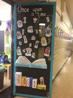 a bulletin board with books and magnets on it in a school hallway or library