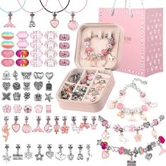 a pink box filled with lots of assorted jewelry