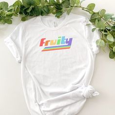 "This \"fruity\" t-shirt is the perfect funny and trendy top for pride month, the pride parade, and all of summer! Makes a great gift for your gay / LGBTQIA+ friends! * 100% combed and ring-spun cotton (Heather colors contain polyester) * Fabric weight: 4.2 oz/yd² (142 g/m²) * Pre-shrunk fabric * Side-seamed construction * Shoulder-to-shoulder taping * Blank product sourced from Guatemala, Nicaragua, Mexico, Honduras, or the US General Policies: Returns I want everyone to feel happy and confident in my clothing. If it does not fit the way you wanted or there are any issues with quality, please let me know and I will work with you to fix it or get a refund! See more about my return policies on my shop page.  Sizing Body positivity is a highly-held value of this shop. For that reason, I do n Cheap Graphic Tee For Pride, Cotton T-shirt With Rainbow Print For Pride, Relaxed Fit Crew Neck T-shirt For Pride, Trendy Cotton T-shirt With Rainbow Print, Trendy Multicolor Pride T-shirt, Trendy Rainbow Top For Pride, Trendy Crew Neck T-shirt For Pride, Pride Multicolor Short Sleeve Tops, Cotton Slogan T-shirt For Pride