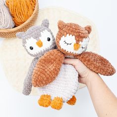 two crocheted stuffed animals sitting next to each other on top of a table