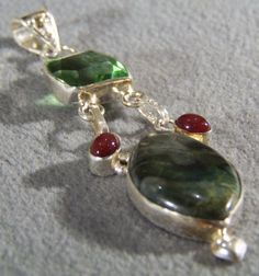 I am offering you this truly exquisite vintage unique domed tear drop / pear shaped pendant charm with a huge rarely found marbleized jasper bezel set stone. It is accented with a bold square shaped peridot stone and 2 oval shaped red onyx stones all done in silver. So very elegant and a very bold, it has a frame / setting with a huge hinged bail . This lavaliere pendant charm is very bold measuring a full 3 1/4 inch by app. 3/4 inch, you will be noticed when wearing this lavaliere pendant. It w Pear Shaped Pendant, Porcelain Candle, Peridot Stone, Rochester Ny, Unusual Design, Onyx Stone, Frame Set, Silver Wedding, Tear Drop