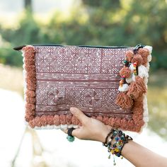 "This beautiful Bag was made by the HMONG hill tribes of Lanna Country (Northern Thailand). It features the edge of bag with two tone pom pom. This bag is zipper closure and one zippered pocket inside. We buy materials from Hmong market and we design and sew by hand. Some of the bags we modify to improve the product. The Hmong tribes live in the North of Thailand and have origins from the Tibetan area of China. Approx Measurement Length: 12\" inches, 30 cm Height: 8\" inches, 20 cm Shipping Orde Bohemian Clutch Bag With Tassels, Bohemian Tassel Clutch Bag, Handheld Woven Bohemian Shoulder Bag, Bohemian Woven Handheld Shoulder Bag, Bohemian Clutch Shoulder Bag With Tassels, Bohemian Tassel Clutch Shoulder Bag, Bohemian Clutch Pouch For Daily Use, Rectangular Woven Clutch For Festival, Bohemian Pouch Shoulder Bag With Tassels