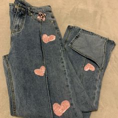 a pair of jeans with pink hearts on them