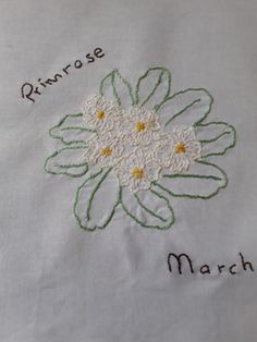 a close up of a white cloth with flowers on it and the words princess march written in cursive writing