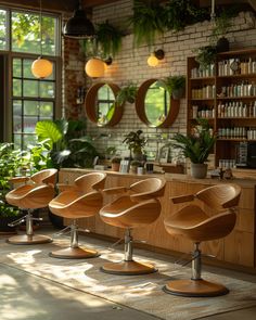 a row of chairs sitting in front of a window next to a plant filled wall