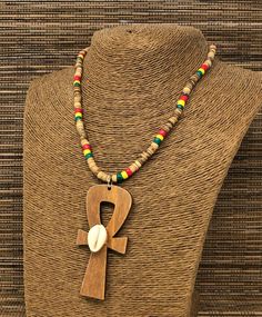 "Rasta Beaded Necklace. Natural Wood Ankh Necklace Pendant. Handmade Ankh Wooden Pendant. Unisex Design. Necklace is 17\" Inches Around the Neck Meaning of Ankh Cross: ancient symbol of life on Egypt Ankh Pendant Dimensions: 3\" Inches Long FAST & FREE SHIPPING! Visit my Etsy Shop to see more Handmade Africa Jewelry! At Freedom Life Style Jewelry you will find a variety of Africa Necklaces and Africa Earrings. Click here to see more designs: https://www.etsy.com/shop/FreedomLifeStyle" Bohemian Ankh Jewelry For Festivals, Bohemian Ankh Shaped Jewelry For Festivals, Traditional Ankh Necklace For Gifts, Bohemian Ankh Necklace For Festivals, Handmade Ankh Necklace For Festivals, Egypt Ankh, Africa Jewelry, Rasta Earrings, Eye Of Horus Necklace