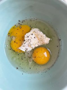 two eggs in a bowl with some seasoning on them