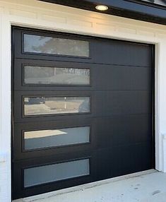 a black garage door on the side of a house