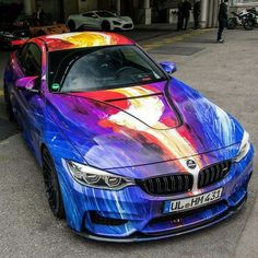 a colorful bmw car parked on the street