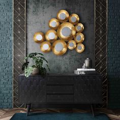 a black and gold sideboard in front of a brick wall with mirrors on it