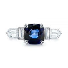 a blue and white diamond ring with three baguets