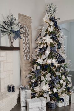 a white christmas tree with blue and silver decorations