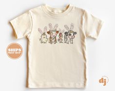 Toddler T-shirt - Bunny Eared Farm Animals Kids Retro T-Shirt - Retro Natural Infant, Toddler & Youth Tee #6145 All of the shirts and bodysuits at our shop are CPSIA compliant. We only use Eco-friendly, water-based inks that are also CPSIA compliant and boasts strong washability (highest score on AATCC wash test).  So rest assure to put them on your little ones!  ** COLOR OF T-SHIRTS WILL VARY SLIGHTLY DUE TO LIGHTING AND/OR MONITOR SETTINGS ** DETAILS OF BABY BODYSUITS & T-SHIRTS MAY VARY SLIGH Cute Short Sleeve Easter T-shirt, Playful Easter Short Sleeve T-shirt, Cute Easter T-shirt With Short Sleeves, Funny Cartoon Print T-shirt For Spring, White Crew Neck T-shirt For Easter, Casual Short Sleeve T-shirt For Easter, Cute Easter Crew Neck T-shirt, Playful Easter T-shirt With Short Sleeves, Cute Easter T-shirt With Crew Neck