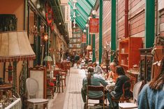 people sitting at tables in an old fashioned store