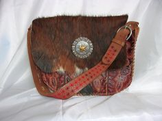 Thank you for shopping my luxurious, handcrafted Western leather handbags, purses, and totes created uniquely from reclaimed cowboy boots. I have been wrangling boots into purses for more than a decade and each new one is my favorite. I hope you enjoy picking out your first one! Each piece tells a story, echoing the rugged beauty and timeless elegance of the Old West. The meticulous craftsmanship ensures that no two bags are alike, offering a one-of-a-kind accessory that stands out in any crowd. Western Style Bags With Concho, Western Bags With Concho Detail, Western Style Hand Tooled Brown Bag, Western Style Brown Bag With Concho, Brown Hand Tooled Bag For Rodeo, Hand Tooled Brown Bag For Rodeo, Hand Tooled Brown Bags For Rodeo, Western Style Brown Bags For Rodeo, Brown Rectangular Bag For Rodeo