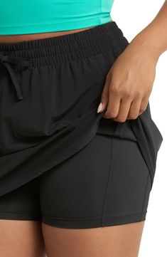 A high-waist skort with an elastic waistband and built-in shorts keeps you moving securely and comfortably through every workout. 15 1/2" front length; 4" inseam; 18" leg opening (size Medium) Lined 86% polyester, 14% elastane Machine wash, tumble dry Imported Sporty Swim Skirt With Built-in Shorts, Athleisure Swim Skirt With Elastic Waistband, Sporty Swim Skirt With 4-way Stretch And Built-in Shorts, Athleisure Short Tennis Skirt For Workout, Athleisure Swim Skirt With Built-in Shorts, Athleisure Swim Skirt With Elastic Waistband For Workout, Black 4-way Stretch Tennis Skirt With Built-in Shorts, Athleisure Stretch Tennis Skirt With Elastic Waistband, Black Sports Skort With Built-in Shorts