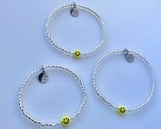 Minimalist Smiley Face Bracelet  You will receive (2) BRACELETS One for you and one for your bestie, bestest cousin, favorite auntie, grandma or mom! Each Bracelets features a stainless steel charm logo.  Made using; metallic lined clear beads, acrylic yellow smiley face bead, stainless steel charm, durable elastic cord.  All orders are Custom and made to order. ✨Sizing Suggestions ✨ * Child 2-4yrs 5.0" * Child 5-7yrs 5.5" * Child 8-10yrs 6.0" - Adult Extra Small 6.0" * Adult Small - 6.5" * Adul Casual Hypoallergenic Bracelets As Best Friend Gift, Trendy Hypoallergenic Friendship Bracelet For Best Friend, Trendy Silver Beaded Bracelets For Birthday, Casual Beaded Bracelets For Best Friend, Trendy Silver Hypoallergenic Friendship Bracelets, Trendy Hypoallergenic Silver Friendship Bracelets, Casual White Beaded Bracelets As Best Friend Gift, Casual White Beaded Bracelet For Best Friend, Trendy Silver Friendship Bracelets With Letter Beads