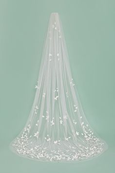 a wedding veil with white flowers on it