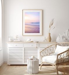 a room with white furniture and a painting on the wall