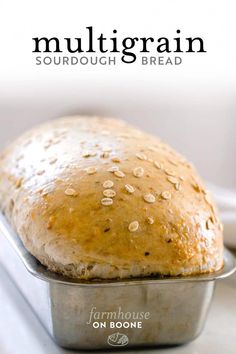 a loaf of bread sitting in a pan on top of a white countertop with the words, multigrain sourdough and bread