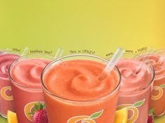 four glasses filled with different types of smoothies