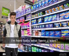 a young man standing in front of a display of toilet paper at a store with the words, i'm here baby what flavor u want?