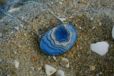 A ring-shaped reef, island, or chain of islands formed of coral The Atoll pendant has been carefully handmade from bonded beach sand, ultramarine or aqua blue resin and metal pigments with a high-gloss polished finish. Two eye screws connect the piece to a fine cable link chain. All metal parts are rhodium plated. Each purchase from BoldB's Aqua Collection will help provide one year of safe water to one person in need through BoldB's support of Water.org, an international nonprofit organisation. Christian Ornaments, Animal Book, Safe Water, Soft Book, Christian Decor, Bar Glassware, Gift Kit, Memorial Keepsakes, Beach Sand