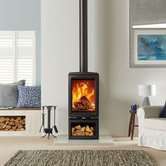 a living room filled with furniture and a fire place in the middle of the room