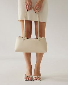 The bigger sister of our Caroline bag, a little larger, a little softer, a bit more daytime. Understated, sophisticated, and unique, the Chrystie is destined to be an inevitable classic for years to come. Perfectly sized for holding all the essentials, and features a magnetic folding top closure, 4 large interior pockets, and one key clip. Classic Cream Bags With Rolled Handles, Timeless Baguette Bag With Detachable Handle For Daily Use, Classic Satchel With Rolled Handles, Timeless Everyday Satchel In Clutch Shape, Timeless Everyday Satchel Clutch, Elegant Everyday Satchel With Rolled Handles, Formal Beige Shoulder Bag With Rolled Handles, Timeless Bags For Everyday Use With Rolled Handles, Timeless Bags With Rolled Handles For Everyday Use