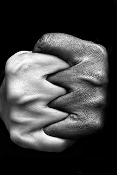 black and white photograph of two hands holding each other