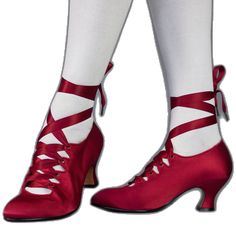 the legs and ankles of a woman wearing red shoes with laces on each side