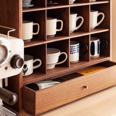 a wooden shelf filled with lots of coffee cups